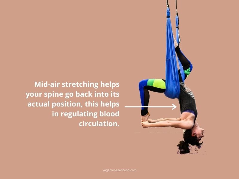 mid air spine position performing aerial yoga